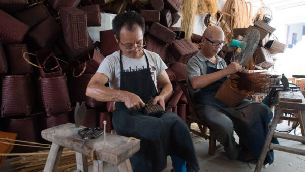 Two craftsmen make traditional bamboo products at a workshop in the county of Anji, eastern China